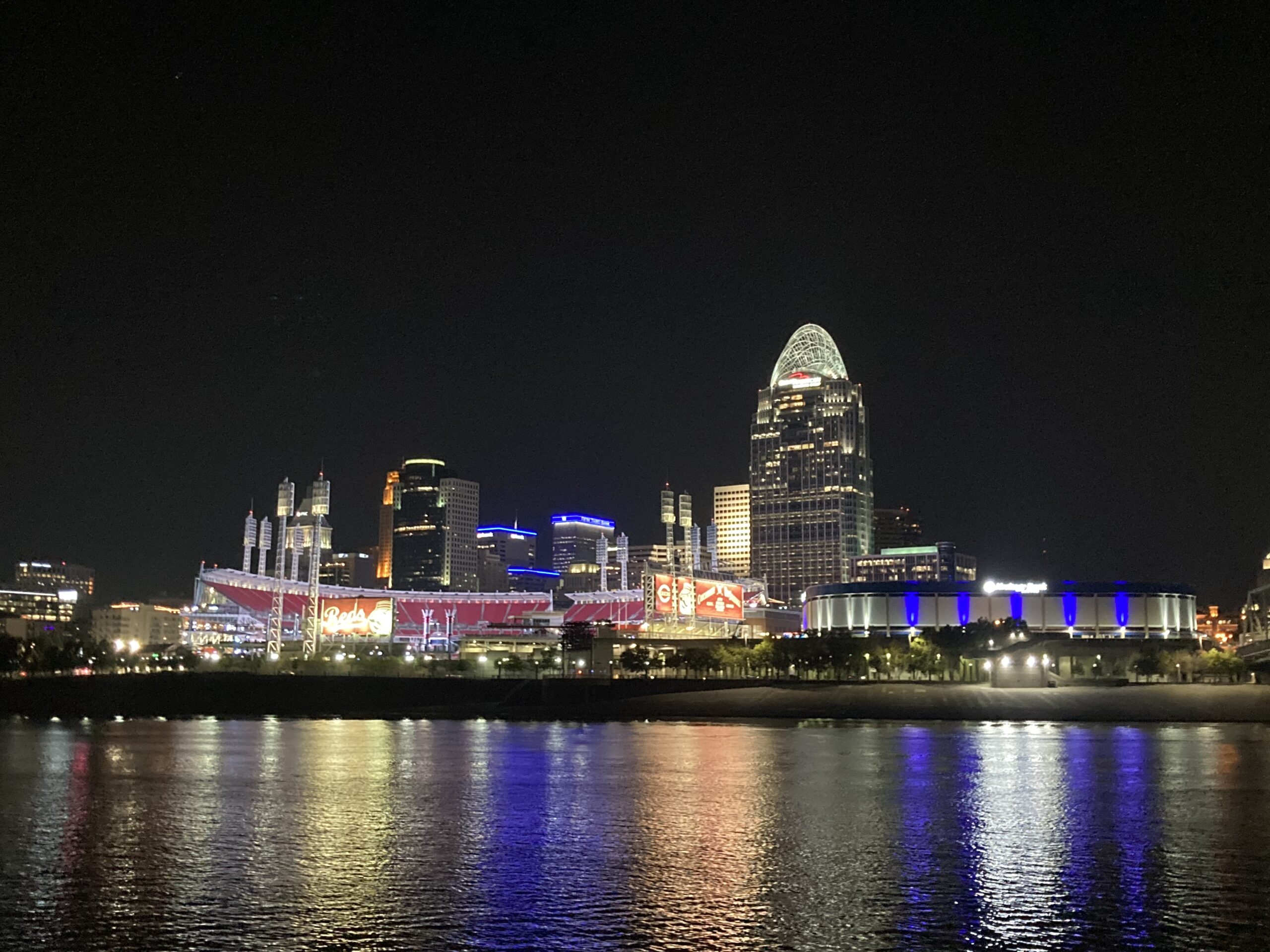 The City of Cincinnati skyline at night as seen from a boat on the Ohio River.