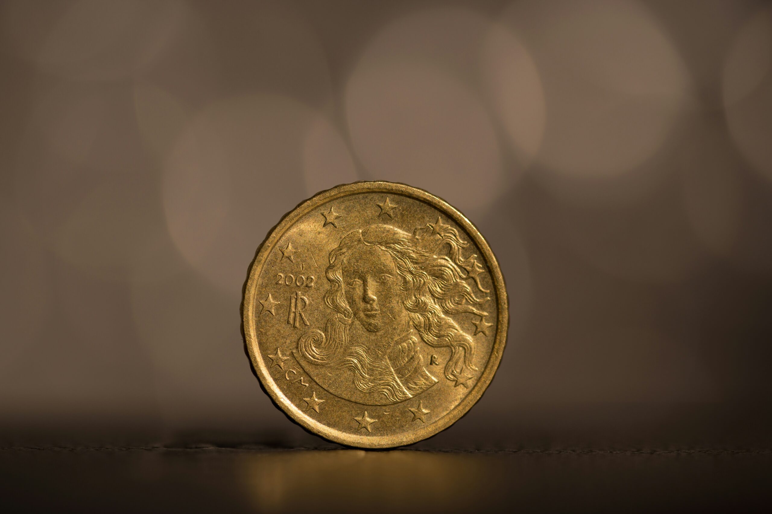 A gold coin against a gray background